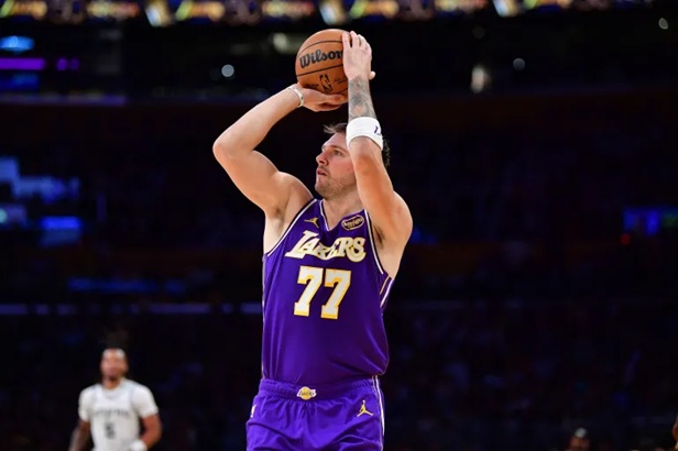 Luka Dončić soaring for a layup while controlling the ball, showing his elite offensive skills and impact as a top NBA player 2026.