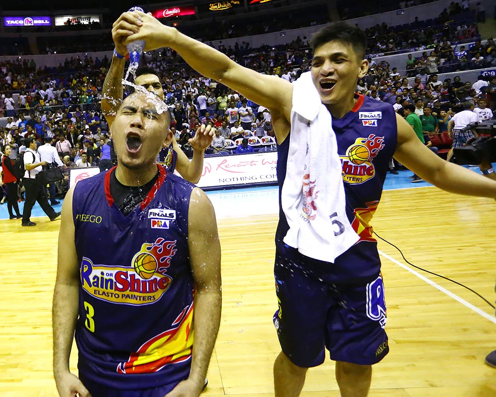 Rain or Shine players celebrating a fast-break dunk | GGSLOT | Sports & Games News Rain or Shine Elasto Painters players celebrating during their 7-1 run in the 2026 Commissioner's Cup.