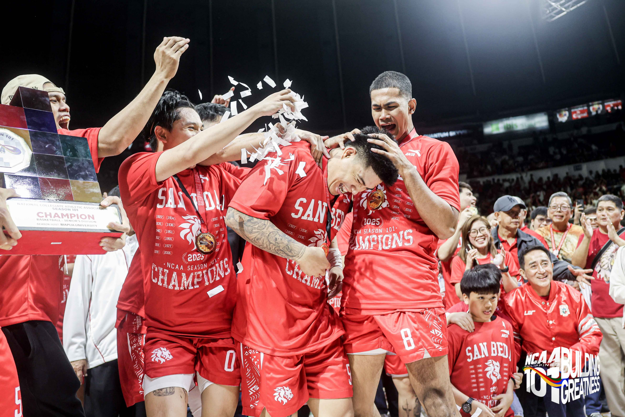 ncaa-philippines-basketball-season-102-tipoff | GGSLOT | Sports & Games News Basketball players in red uniforms celebrate a championship on the court as confetti swirls around them.