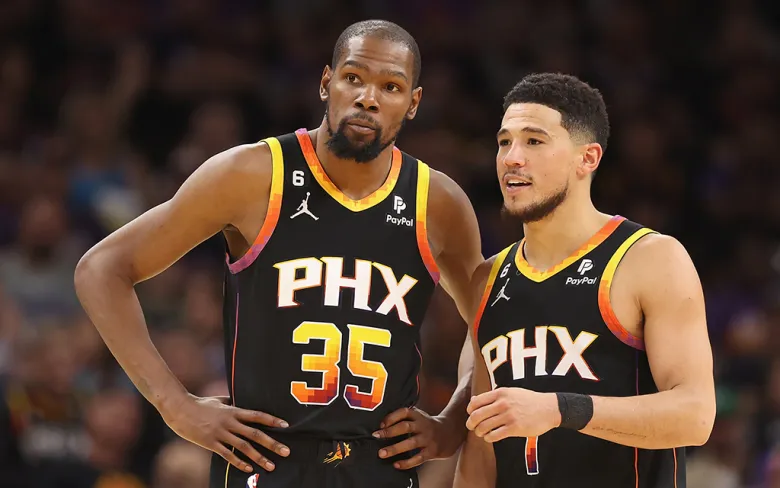 Phoenix Suns stars Kevin Durant and Devin Booker strategizing during NBA Play-in Tournament Day 1