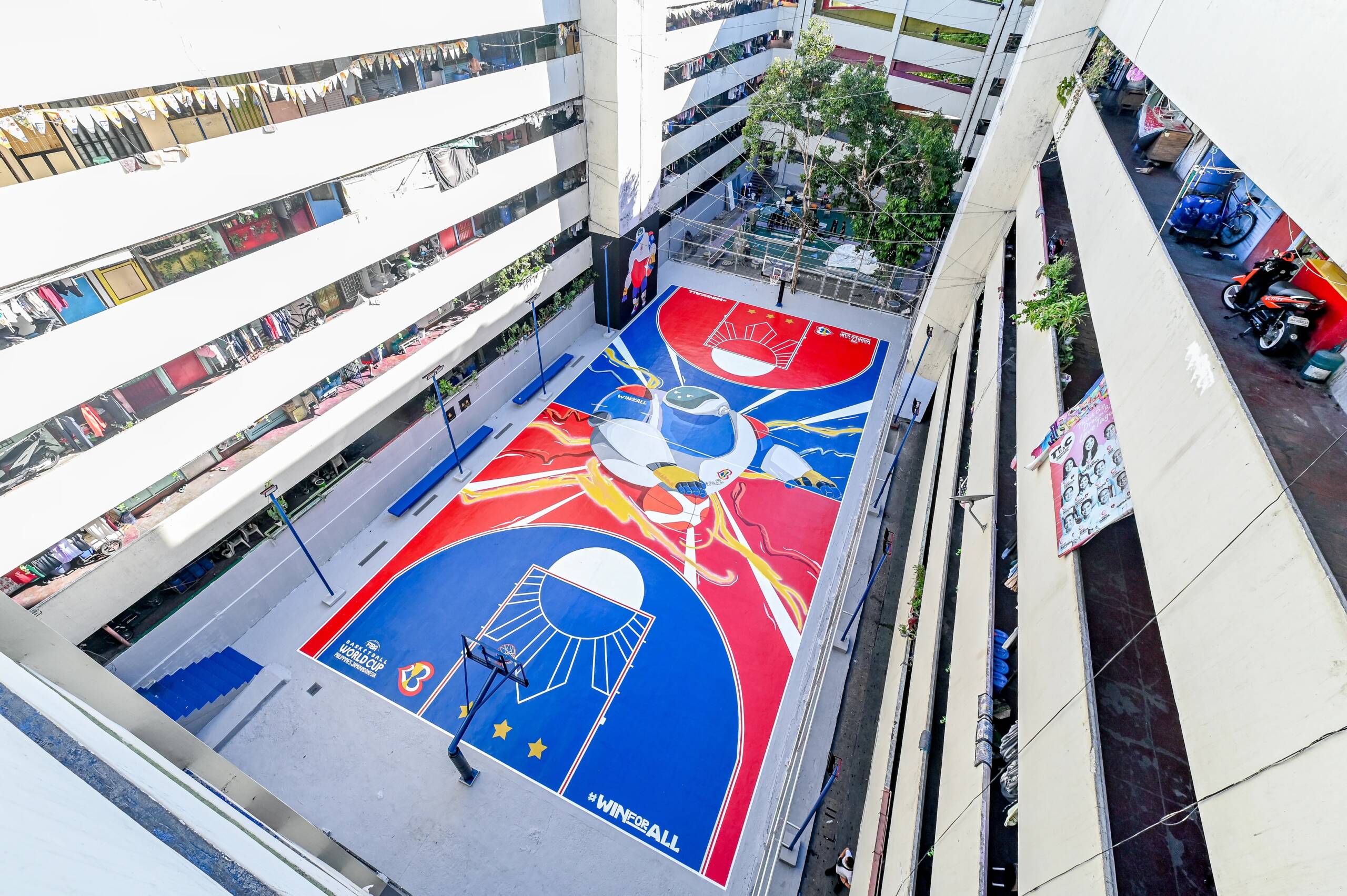 tenement-taguig-basketball-court-manila | GGSLOT | Sports & Games News The Taguig Tenement residential building in Metro Manila features a colorful, hand-painted basketball court that highlights the streetball culture of the area.