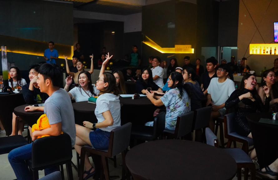 A lively crowd enjoying beer pong and live music at Victoria Sports Bar, a premier Basketball Cafes Manila hangout.