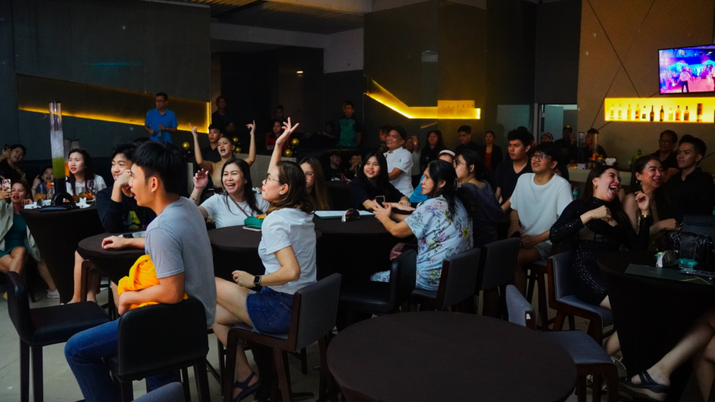 A lively crowd enjoying beer pong and live music at Victoria Sports Bar, a premier Basketball Cafes Manila hangout.