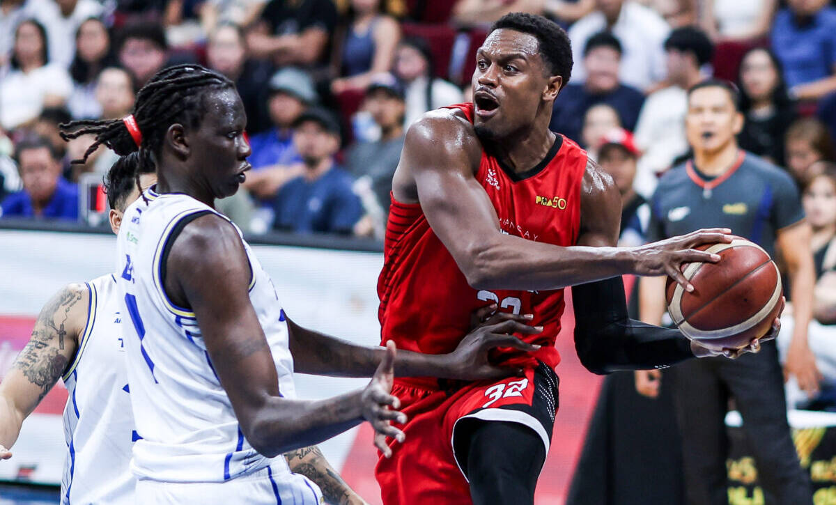 Barangay Ginebra and Phoenix Fuel Masters players battling for position in a PBA Quarterfinals game