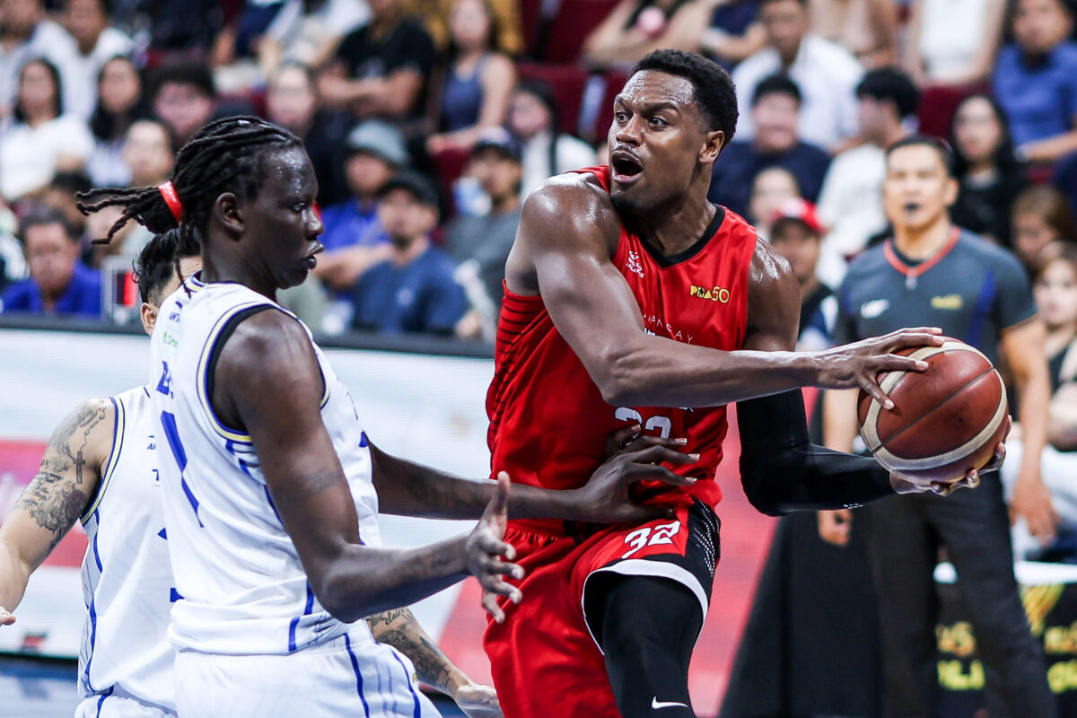 Barangay Ginebra and Phoenix Fuel Masters players battling for position in a PBA Quarterfinals game