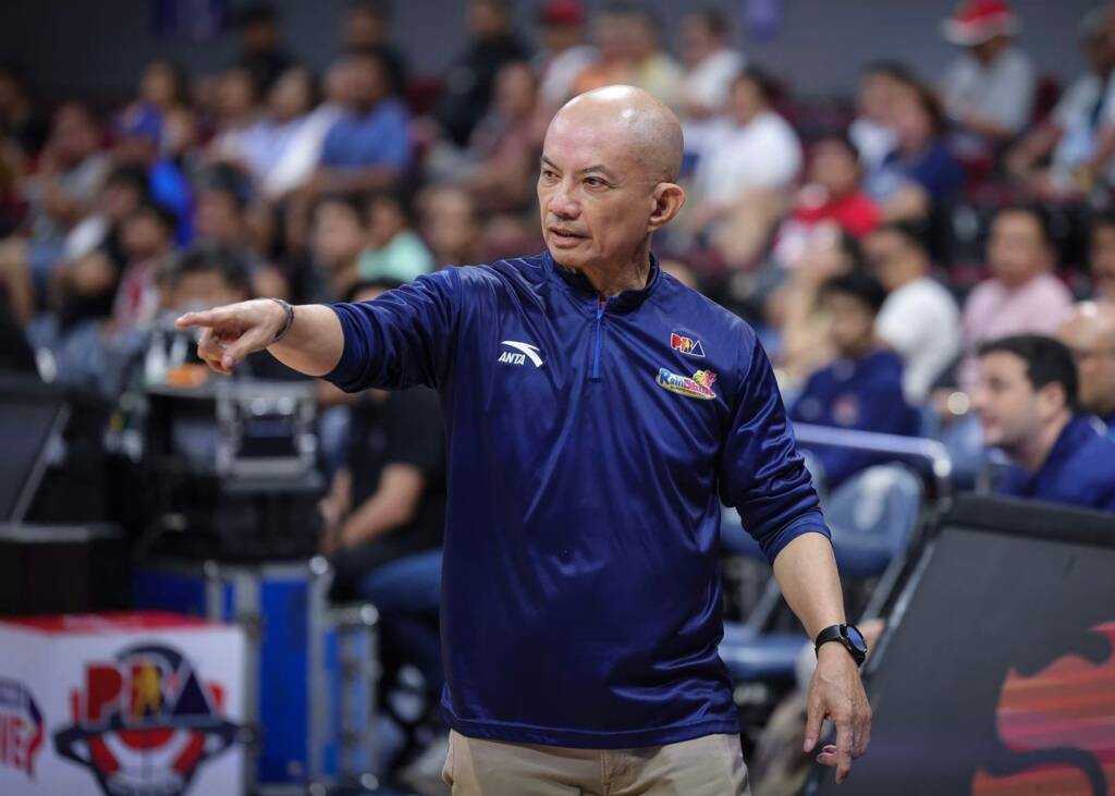 Coach Yeng Guiao gesturing passionately during a timeout, illustrating the tactical depth of the Rain or Shine PBA system