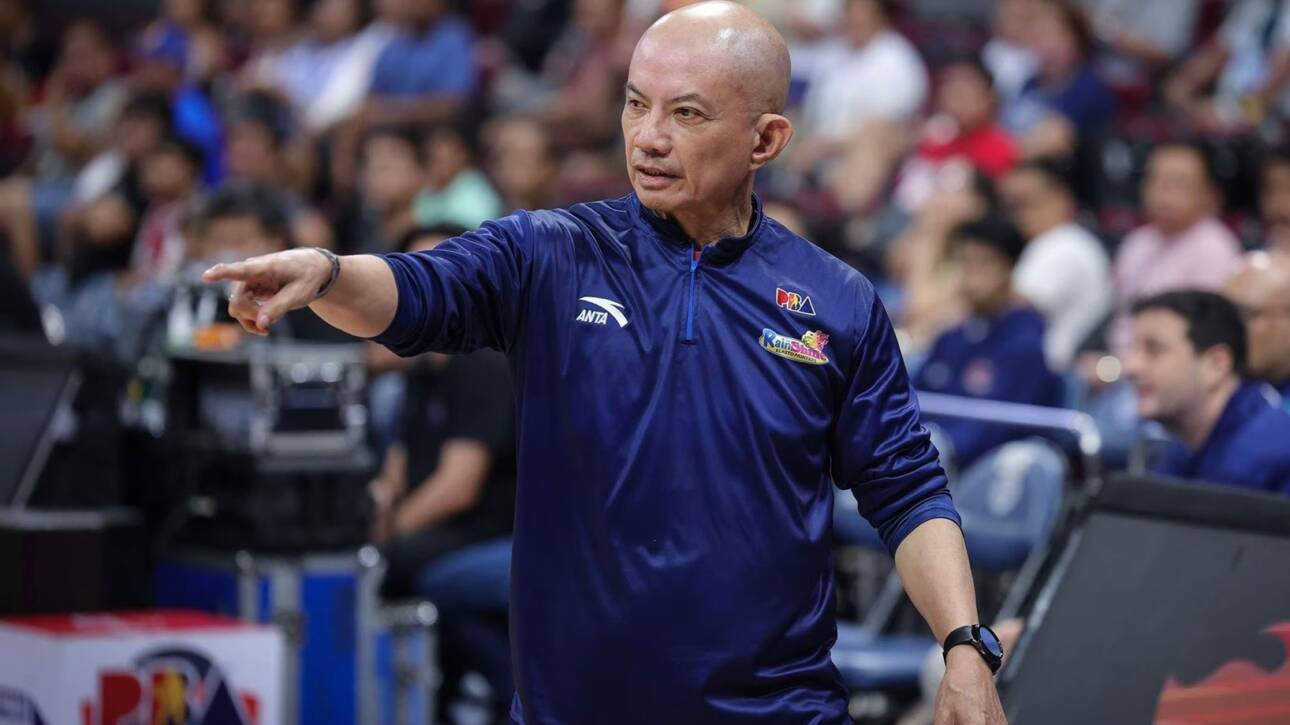 Coach Yeng Guiao gesturing passionately during a timeout, illustrating the tactical depth of the Rain or Shine PBA system