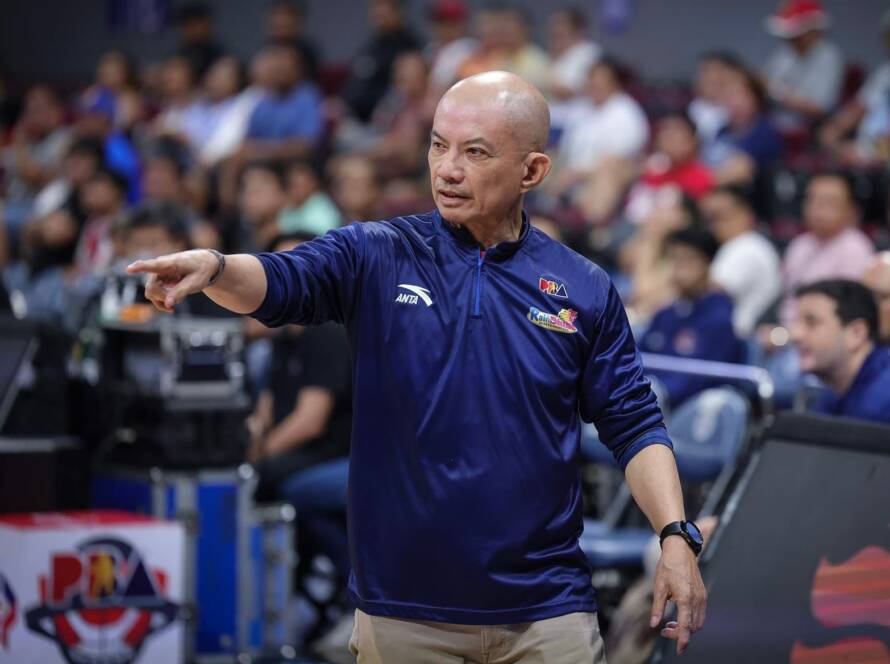 Coach Yeng Guiao gesturing passionately during a timeout, illustrating the tactical depth of the Rain or Shine PBA system