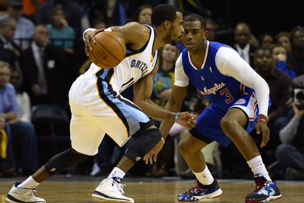 A dynamic point guard driving down the court and directing the offense during an international basketball game.
