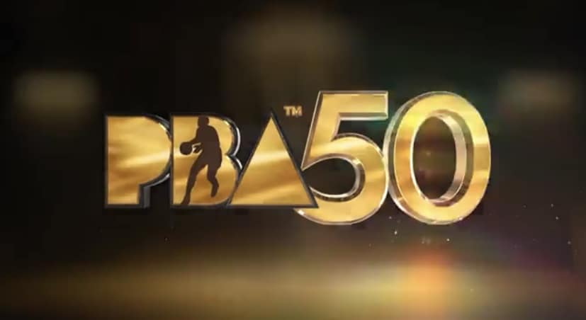 Close-up of the official PBA 50th Anniversary commemorative gold logo shining on a basketball court