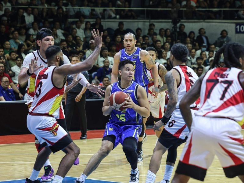 Intense action shot of players from San Miguel and TNT battling for a loose ball during PBA Finals Game 3.