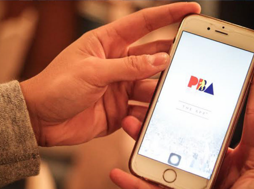 A basketball fan using a smartphone to check live scores and updates during a PBA game