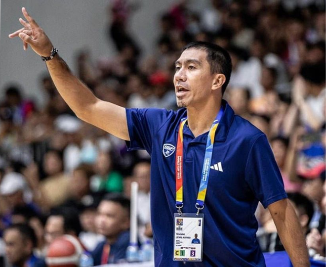 LA Tenorio in a Magnolia Hotshots coaching polo, giving instructions during a timeout.