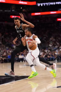 Jalen Brunson driving past Victor Wembanyama during a high-intensity play in the 2026 NBA Finals | GGSLOT | Sports & Games News