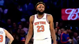 New York Knicks center Mitchell Robinson defending the paint during a game | GGSLOT | Sports & Games News New York Knicks center Mitchell Robinson defending the paint during a game.