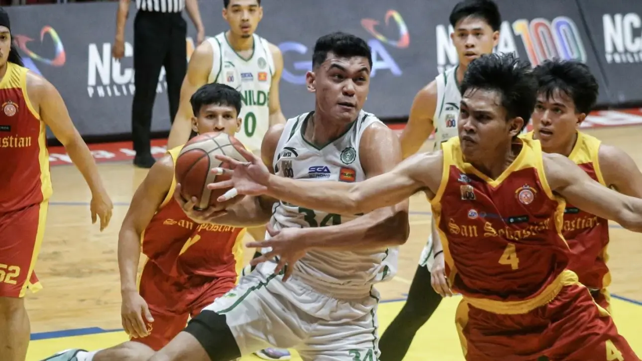 Benilde Blazers guard Matthew Jucom driving past a San Sebastian defender in the 19th Preseason Cup.