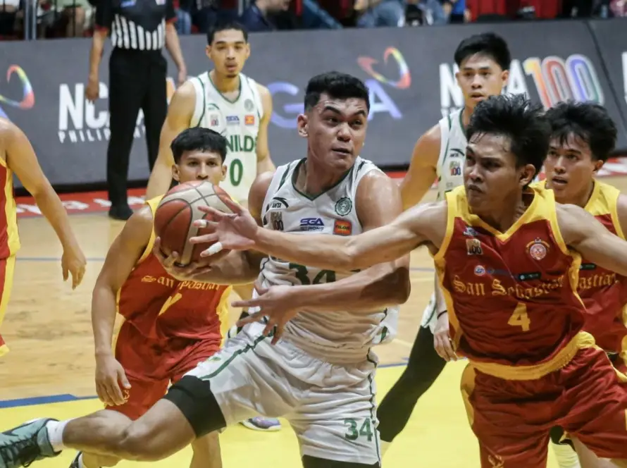 Benilde Blazers guard Matthew Jucom driving past a San Sebastian defender in the 19th Preseason Cup.