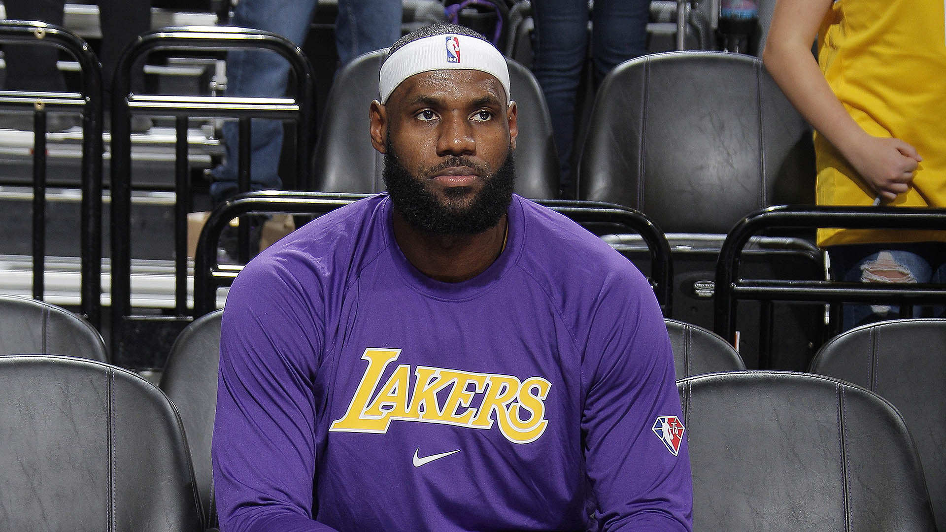 Los Angeles Lakers v Sacramento Kings | GGSLOT | Sports & Games News LeBron James in Lakers gear looking thoughtful while sitting on the bench.