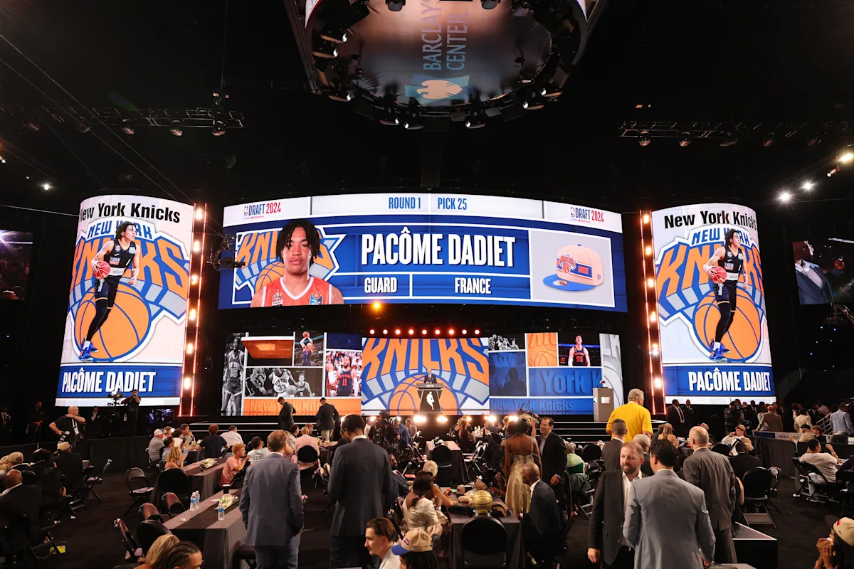 new-york-knicks-nba-draft-2026-picks | GGSLOT | Sports & Games News The official stage at the 2026 NBA Draft in Brooklyn, where the reigning champion New York Knicks insulated their roster with late first-round draft assets.