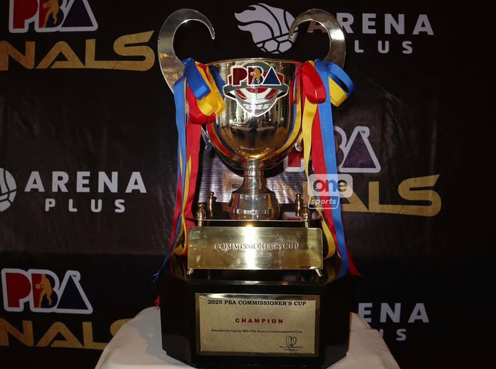 The PBA Commissioner's Cup championship trophy glowing under the arena lights at Smart Araneta Coliseum