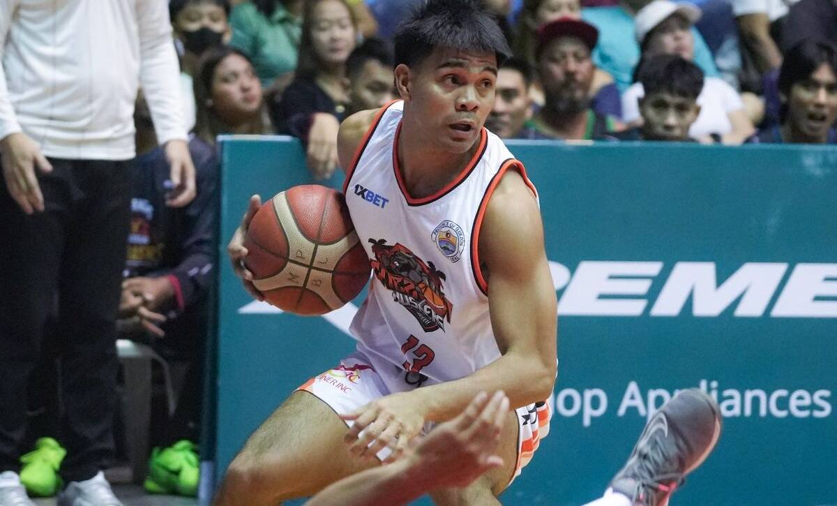 Members of the Quezon Huskers roster executing a defensive stop during a regular season game.