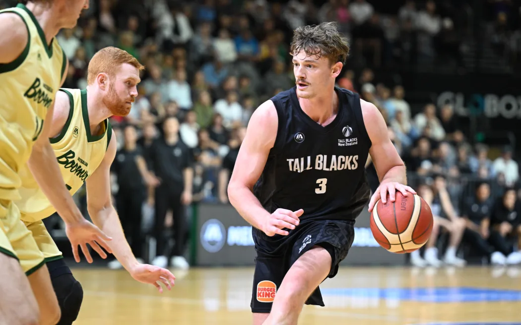 New Zealand basketball team running an offensive play in the half-court.