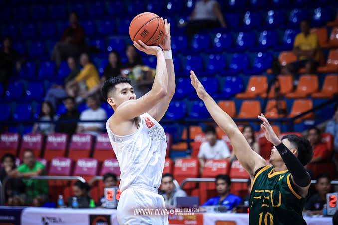 Players from the UP Fighting Maroons basketball team executing a play on court during the 2026 Filoil Cup tournament.