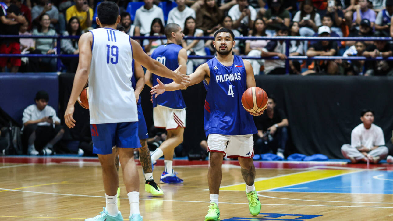 Gilas Pilipinas players defending intensely during an international basketball qualifier.