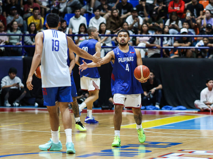 Gilas Pilipinas players defending intensely during an international basketball qualifier.