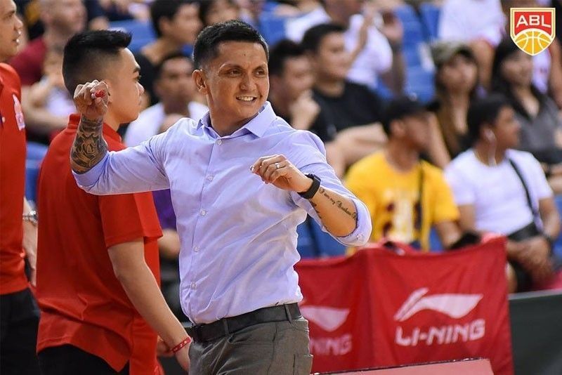 A focused Jimmy Alapag coaching on the sidelines, analyzing the potential of a future Jimmy Alapag NLEX head coach role