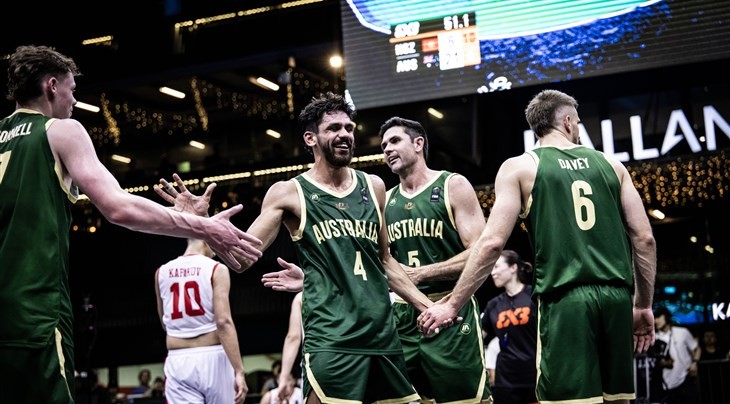 Players from the Australian men's national basketball team executing full-court defensive pressure during a FIBA World Cup Asian Qualifiers game.