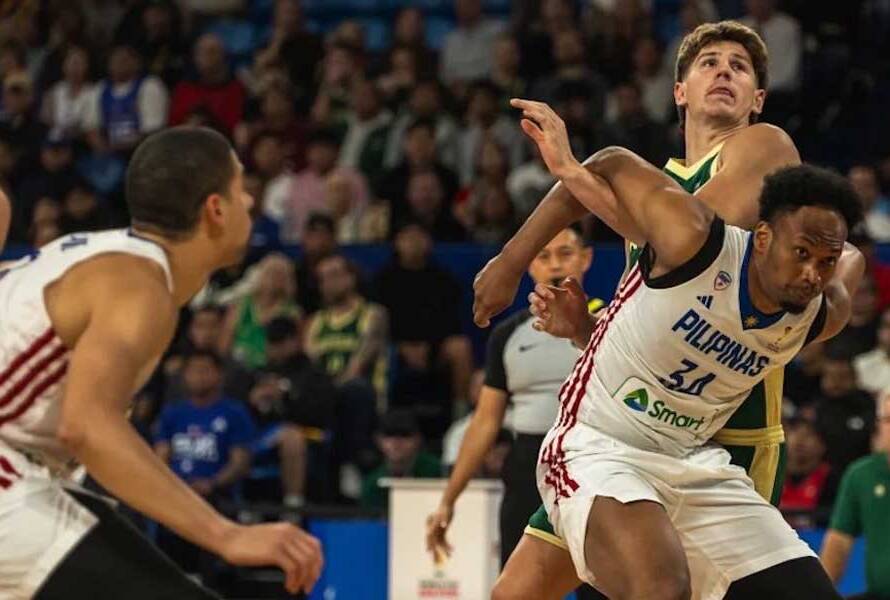 Two basketball players in white and green battle for the ball during a game, with a crowded arena in the background.