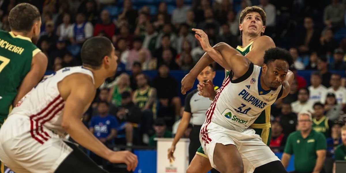 Two basketball players in white and green battle for the ball during a game, with a crowded arena in the background.