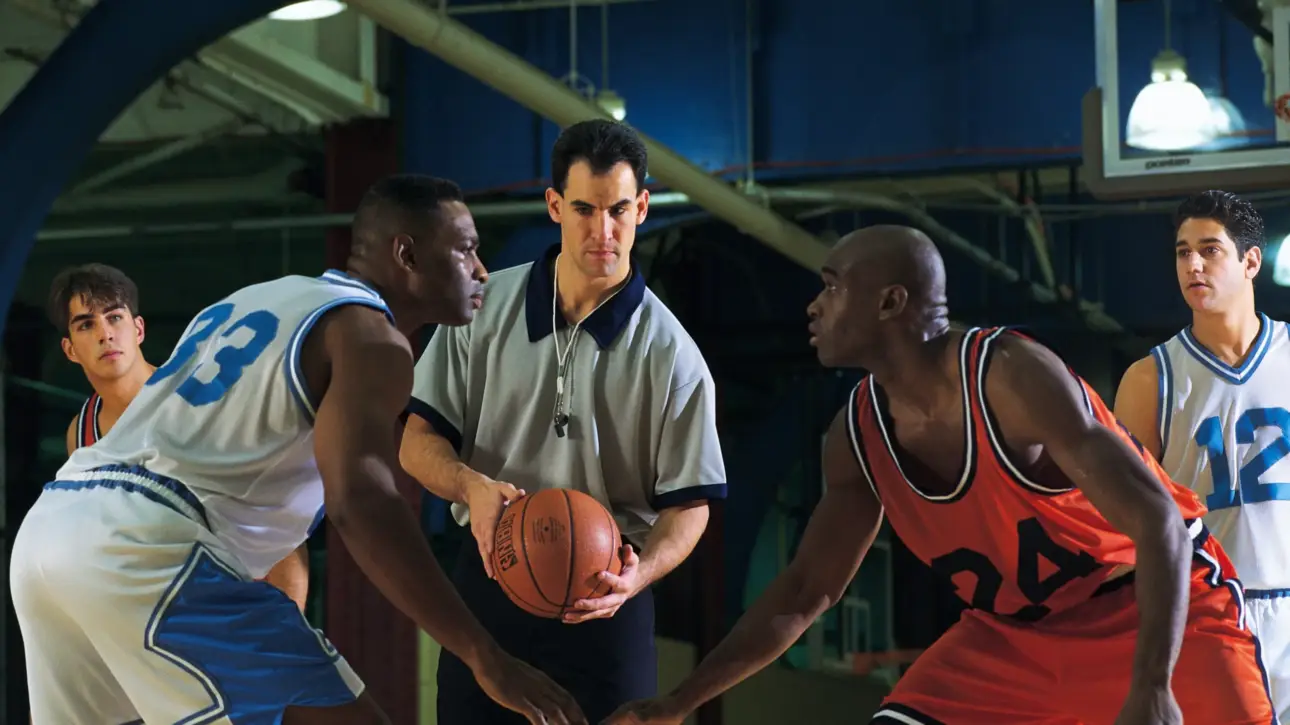 An official match basketball being held by an MPBL referee or player on the court before a game tip-off.