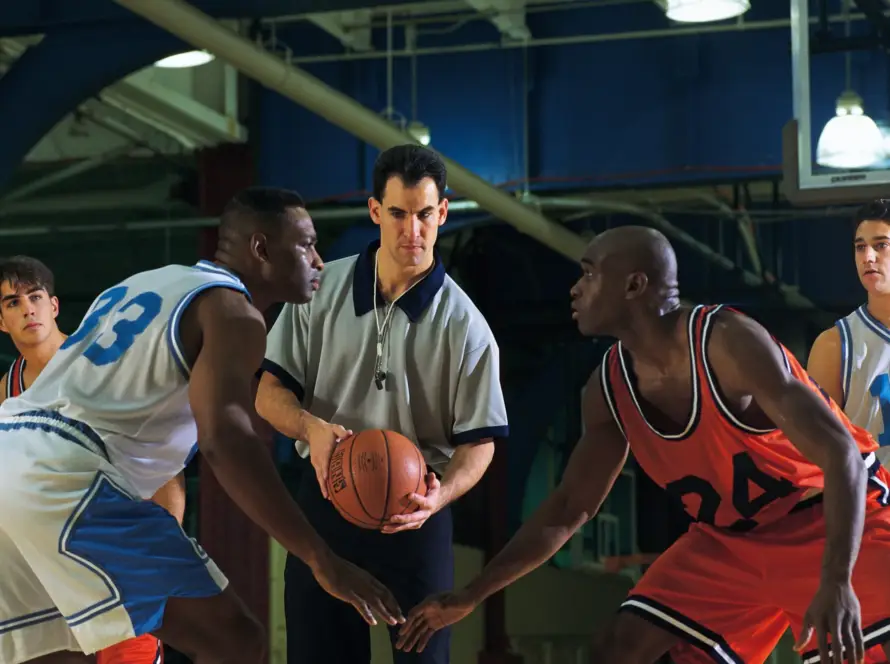 An official match basketball being held by an MPBL referee or player on the court before a game tip-off.
